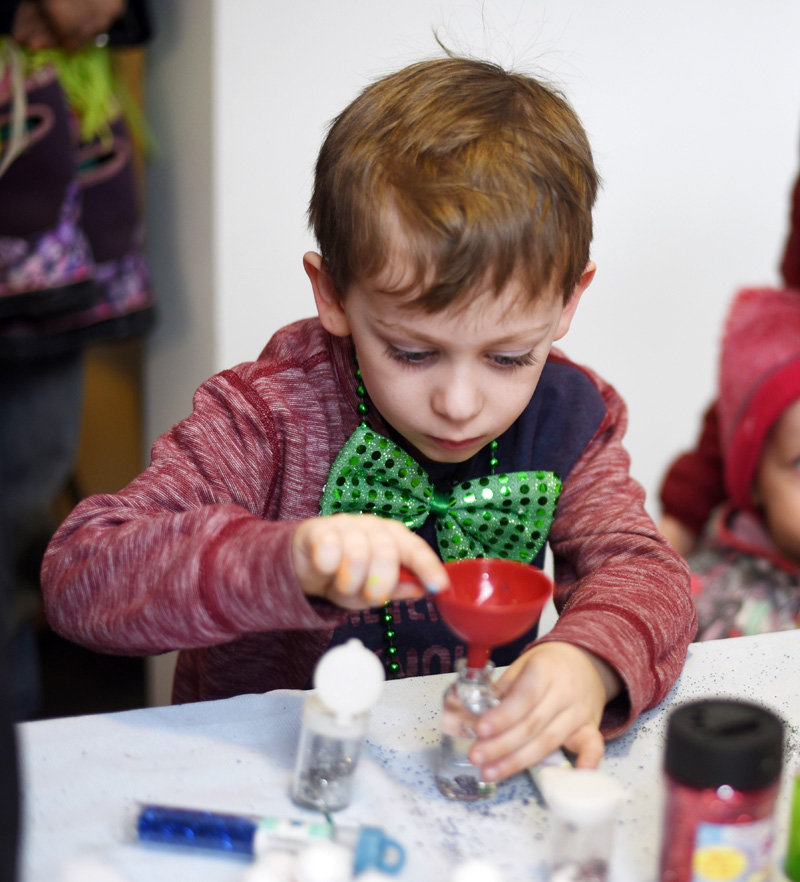 Sawyer Piercy, 5, makes a "nebula in a jar" by mixing glitter, glowsticks, and water during Skidompha Library's "A Wrinkle in Time" event Saturday, March 17. (Jessica Picard photo)