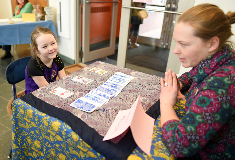 October Brown, 7, gets her fortune read by Skidompha Library Director of Development and Communications Torie DeLisle during the library's "A Wrinkle in Time" event Saturday, March 17. (Jessica Picard photo)