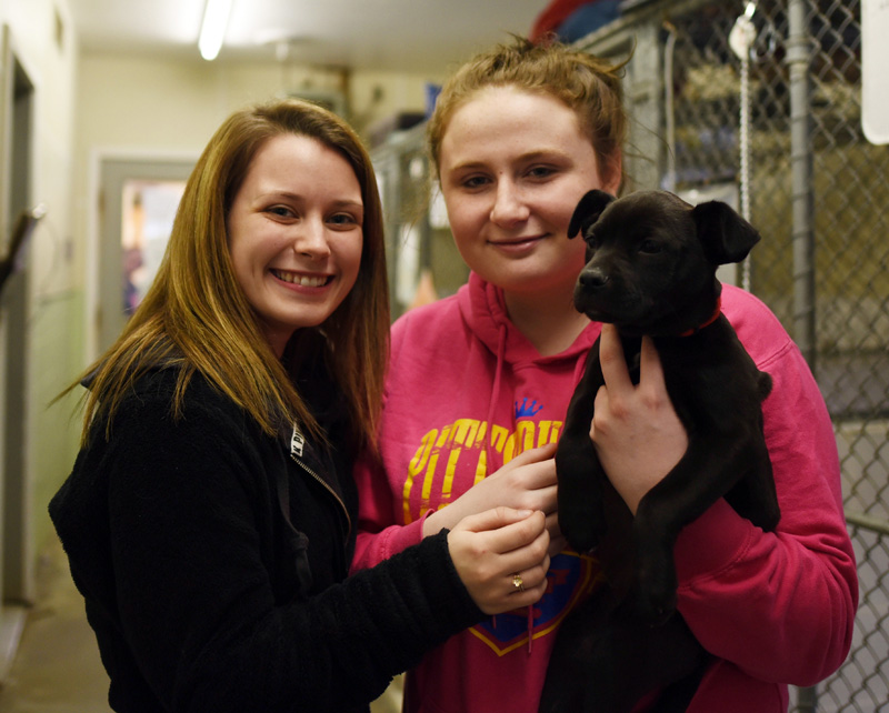 Autumn Sproul (left) and Dakota Beckim hold Sweetie, the 2-month-old puppy they adopted during the Lincoln County Animal Shelter's Puppy Palooza event Saturday, March 3. (Jessica Picard photo)