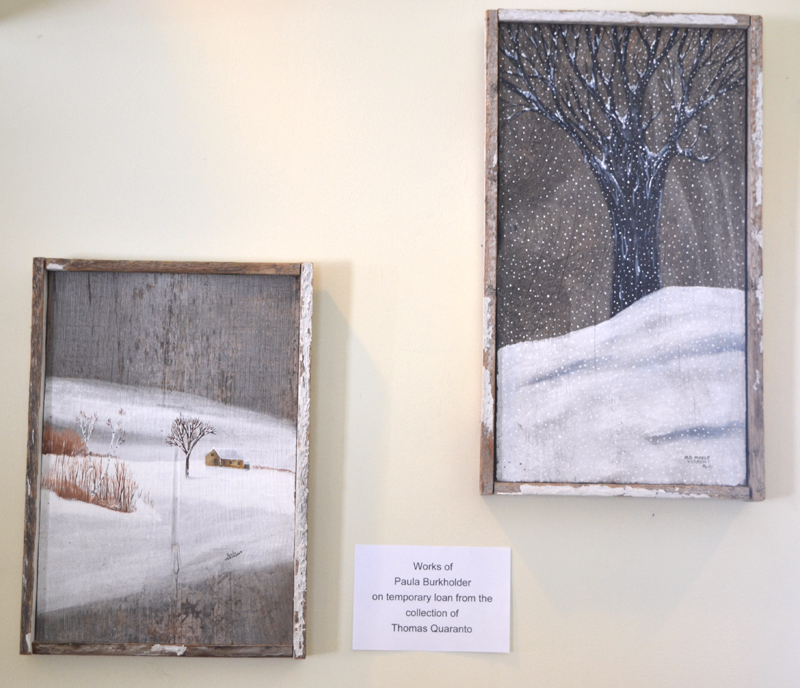 Two winter scenes painted on reclaimed barnwood by Paula Burkholder, on loan to the Wiscasset Public Library from the collection of Thomas Quaranto. (Christine LaPado-Breglia photo)