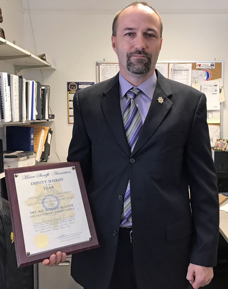 Lincoln County Sheriff's Office Detective Sgt. Ronald Rollins displays his 2018 Deputy Sheriff of the Year plaque in his Wiscasset office Thursday, March 22. (J.W. Oliver photo)