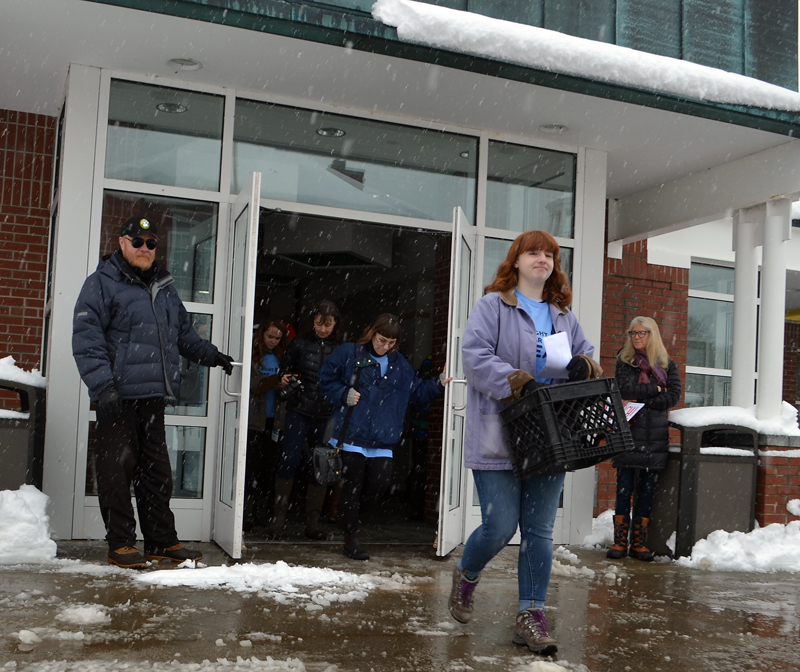 Lincoln Academy senior Hannah Davis leads a walkout from the dining commons the morning of Wednesday, March 14. (Maia Zewert photo)