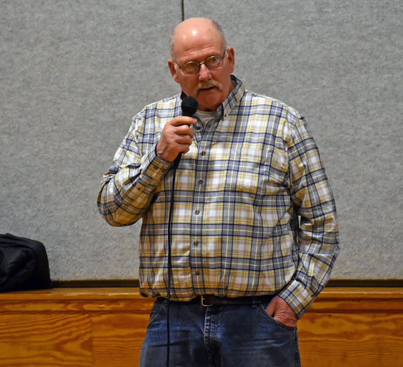 Nobleboro Selectman Richard Powell discusses upcoming repairs to the sidewalks in Damariscotta Mills during town meeting in the Nobleboro Central School gymnasium Saturday, March 17. (Alexander Violo photo)