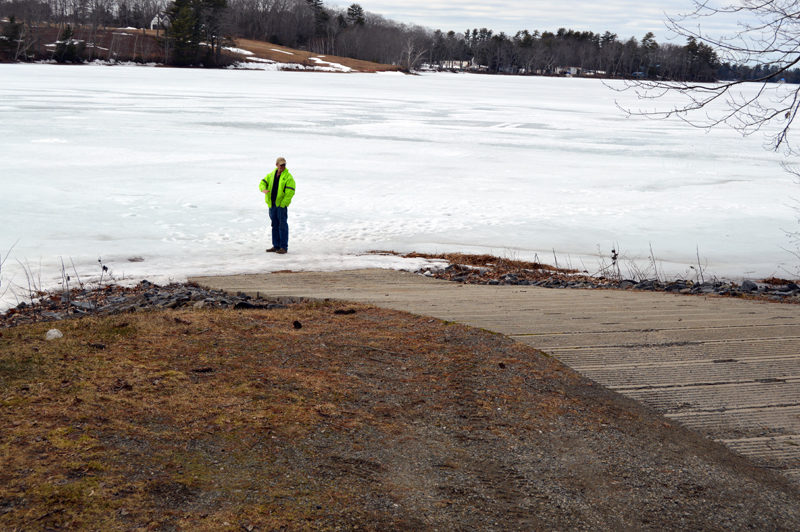 Clary Lake property owner George Fergusson stands on the ice at the boat ramp in Jefferson to show the lake's low water level. (Greg Foster photo)