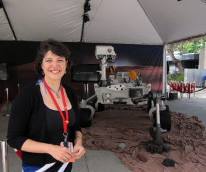 Aileen Yingst with a mockup of the Curiosity rover.