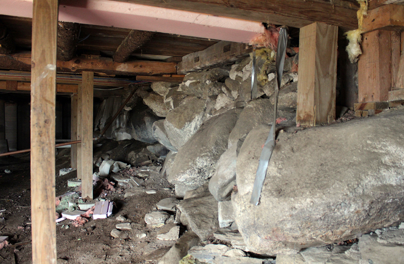 Years of damage from rodent and insect activity and water have caused the foundation under the barn to shift significantly and sink at the southwest corner (right foreground).