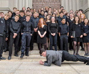 The Lincoln Academy Wind Ensemble on the steps of Riverside Church in New York City, with band director Liz Matta showing off her plank.