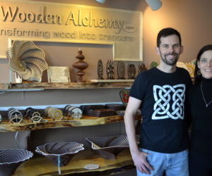 Rob and Barbie Jones stand before shelves holding Rob Jones' wood creations at Wooden Alchemy in downtown Damariscotta. (Christine LaPado-Breglia photo)