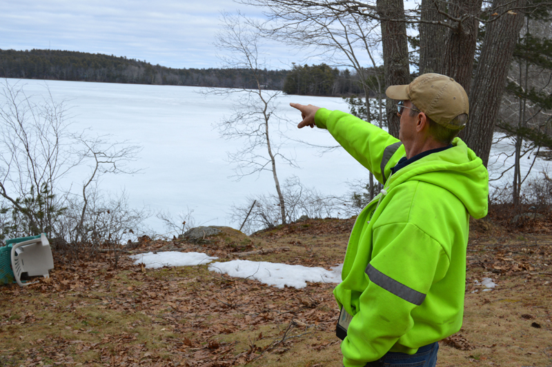 Clary Lake property owner George Fergusson points to his view of the lake in March. The Clary Lake Association is raising money to purchase the Clary Lake Dam and restore the lake's historical water level. (Greg Foster photo, LCN file)
