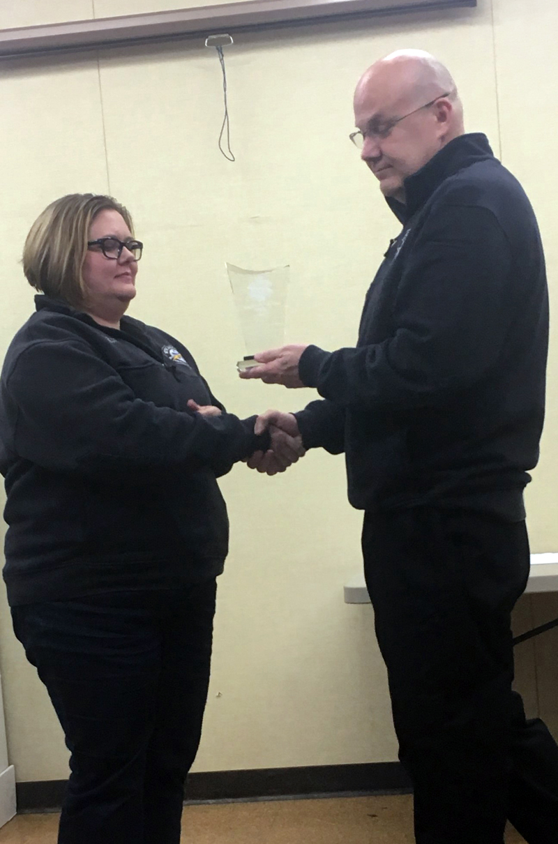 Wiscasset Ambulance Service Emergency Medical Technician Kristin Draper (left) receives the 2017 Employee of the Year trophy from Director Toby Martin.