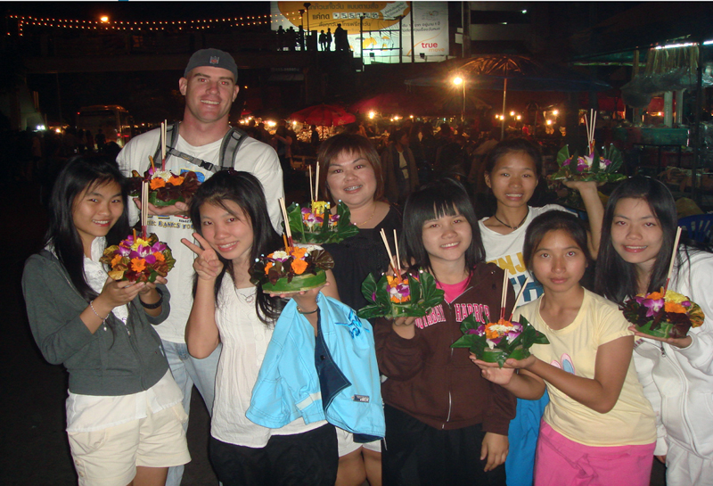 Micah Pexa (back left) poses with some of the Friends of Thai Daughters family in Chiang Rai, Thailand in 2009, when he volunteered for the organization.