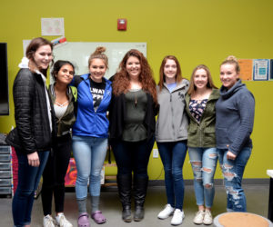 Maia Zewert, of The Lincoln County News, visits the Lincoln Academy Yearbook and Communications Class on Monday, April 9. From left: junior Schuyler Farrell, sophomore Naaz Hussein, senior Khloe Poland, Zewert, junior Alison York, sophomore Madi Bradbury, and junior Sophie Gamage.