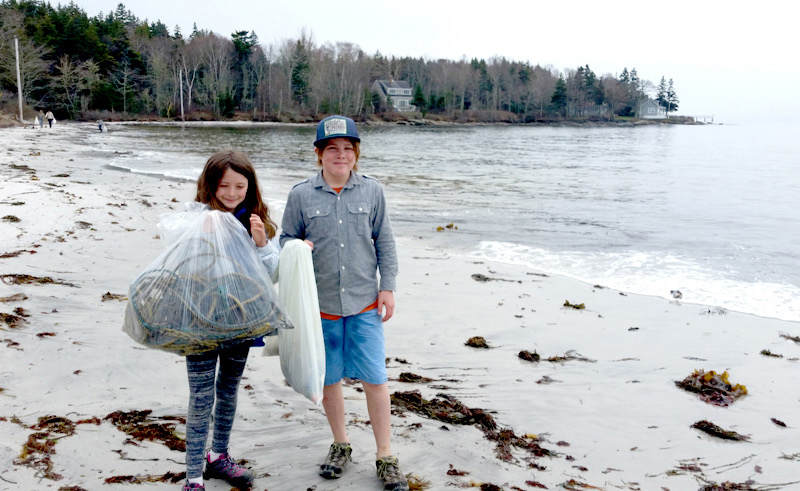 Anna Lupien and Jonas Stepanauskas bring in their haul of garbage found on the beach.
