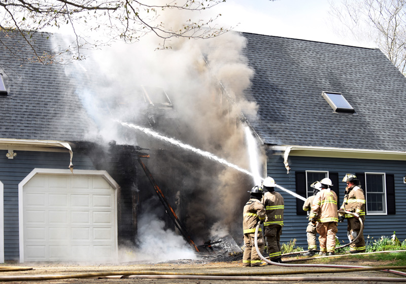 Firefighters attack a fire at 12 Woods Lane in Damariscotta the afternoon of Thursday, May 10. (Jessica Picard photo)