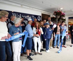 Main Street Grocery owners Gary and Jane Gravel cut the ribbon at the grand opening Friday, May 4, surrounded by employees and members of the Damariscotta Region Chamber of Commerce. (Jessica Picard photo)