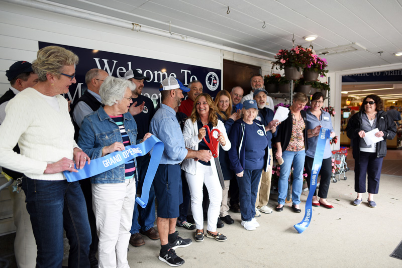 Main Street Grocery owners Gary and Jane Gravel cut the ribbon at the grand opening Friday, May 4, surrounded by employees and members of the Damariscotta Region Chamber of Commerce. (Jessica Picard photo)