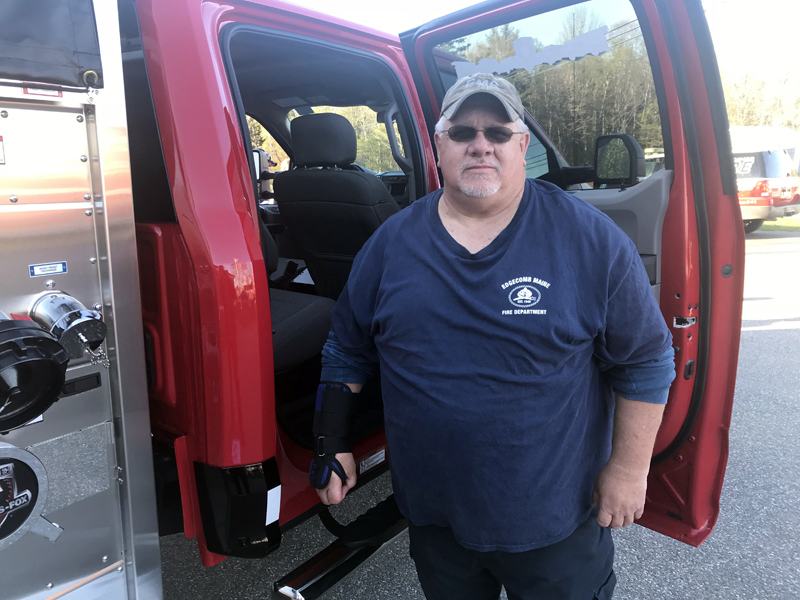 Edgecomb Fire Department Lt. Roland Abbott stands next to a truck similar to the model the department hopes to buy. Abbott has led the department's search for a new truck. (John Maguire photo)