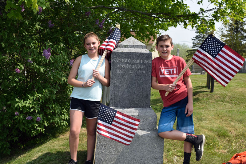 Edgecomb Eddy School sixth-graders and twins Catherine and William Clifford helped decorate veterans' graves in North Cemetery on Friday, May 25, including the grave of Fuller C. Clifford. The twins did not know if he was an ancestor, but were excited to find their family name. (Jessica Clifford photo)