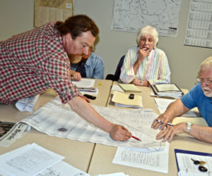 The Edgecomb Planning Board inspects plans for a new building on the Center for Teaching and Learning campus in Edgecomb during a meeting at the town hall Thursday, May 3. From left: CTL volunteer Ross Branch, board members Gretchen Burleigh-Johnson and Jackie Lowell, and board Chair Jack French. (Greg Foster photo)
