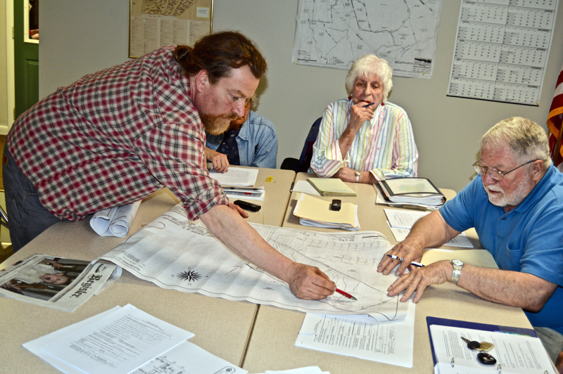 The Edgecomb Planning Board inspects plans for a new building on the Center for Teaching and Learning campus in Edgecomb during a meeting at the town hall Thursday, May 3. From left: CTL volunteer Ross Branch, board members Gretchen Burleigh-Johnson and Jackie Lowell, and board Chair Jack French. (Greg Foster photo)