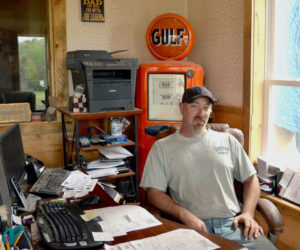 Twisted Iron Customs owner Mike Benner in his office at the business's new Edgecomb location. (Maia Zewert photo)