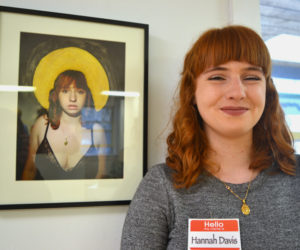 Lincoln Academy senior Hannah Davis stands alongside her self-portrait, "Mary," a digital photograph enhanced with acrylic paint, at the closing reception for the LA Student Art Show at River Arts. (Christine LaPado-Breglia photo)