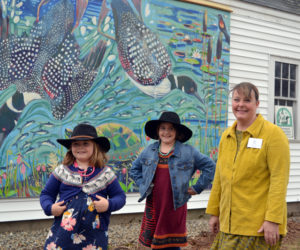 Susan Bartlett Rice and her daughters, Helen (left) and Amelia, in front of Rice's mural on the Pemaquid Watershed Association office during the reception for Rice's "Blooms and Loons" show April 20. (Christine LaPado-Breglia photo)