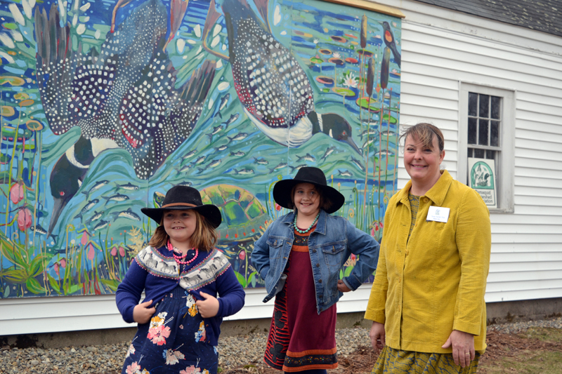 Susan Bartlett Rice and her daughters, Helen (left) and Amelia, in front of Rice's mural on the Pemaquid Watershed Association office during the reception for Rice's "Blooms and Loons" show April 20. (Christine LaPado-Breglia photo)