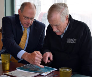 Damariscotta Town Manager Matt Lutkus (left) and U.S. Sen. Angus King review a map of downtown Damariscotta during a meeting about coastal resiliency at Sarah's Cafe in Wiscasset on Friday, April 27. (J.W. Oliver photo)