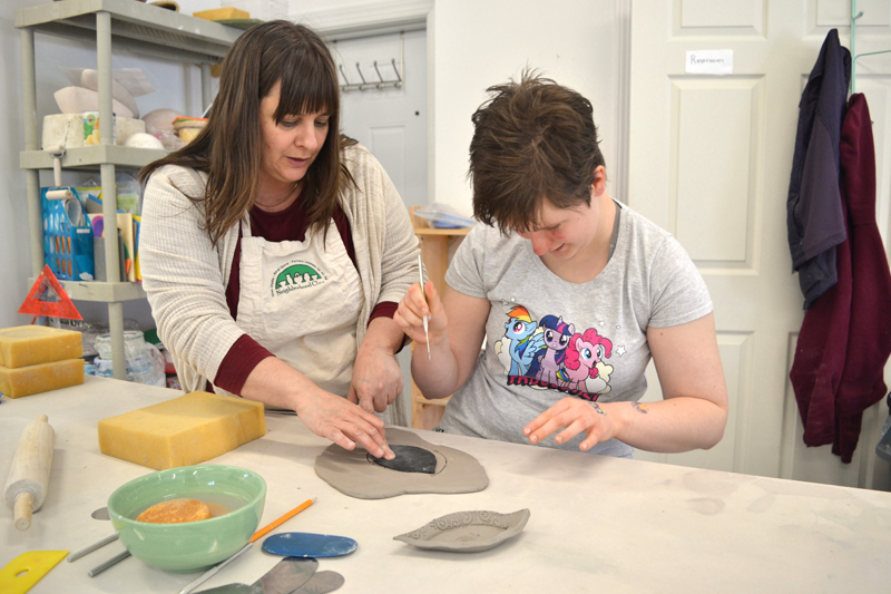 Ceramicist Liz Proffetty instructs the author's daughter on how to make a "push plate" on Saturday, May 5 at Neighborhood Clay in Damariscotta during the Maine Pottery Tour. (Christine LaPado-Breglia photo)