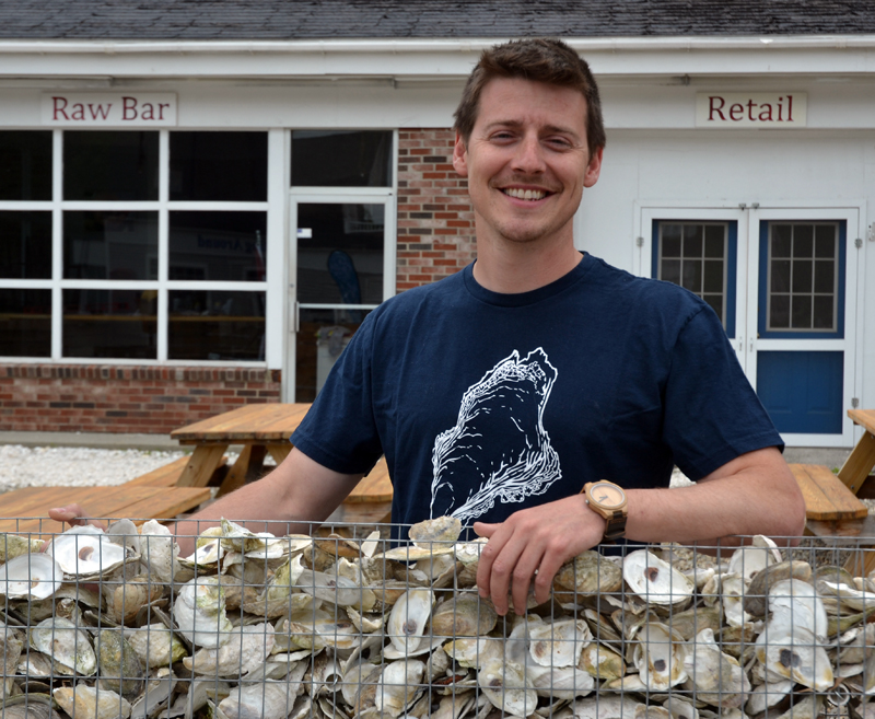 Brendan Parsons stands in front of Shuck Station, at 68 Main St. in Newcastle. The raw bar will open for its second season Saturday, June 2. (Maia Zewert photo)