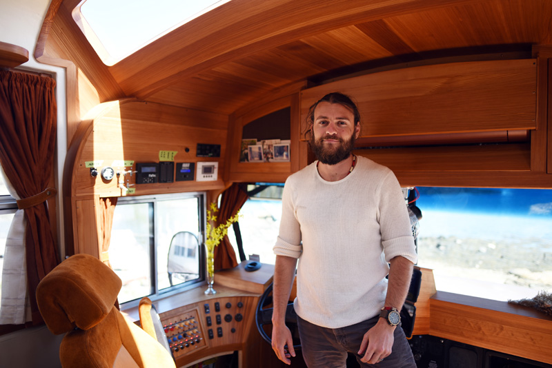 Jeff Osborne stands in the cockpit of his school bus-turned-recreational vehicle Tuesday, May 8. (Jessica Picard photo)