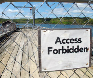 A fence blocks access to an aging pier at the University of Maine's Darling Marine Center, on the Damariscotta River in Walpole. (Bill Trotter photo/Bangor Daily News)