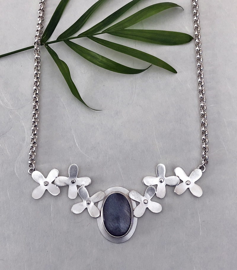 A silver-flower moonstone necklace chain by Christine Peters.