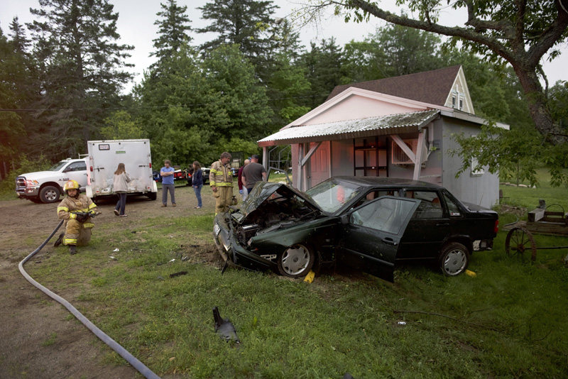 Bristol firefighters work at the scene of a car crash at 1926 Bristol Road in Bristol the evening of Saturday, June 23. (Jessica Picard photo)