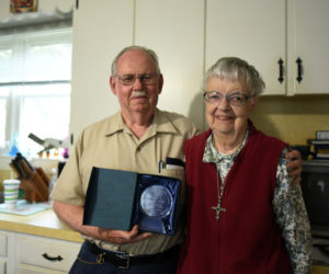 Calvin and Marjorie Dodge pose with an award for outstanding community service in their Damariscotta home Thursday, June 15. (Jessica Picard photo)