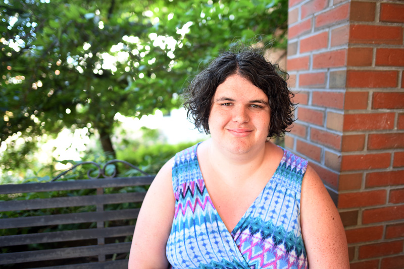 Quinn Gormley sits in front of Skidompha Library in Damariscotta on Wednesday, June 13. USA Today recently recognized Gormley for her work as executive director of the Maine Transgender Network. (Jessica Picard photo)