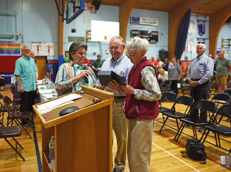 Damariscotta Board of Selectmen Chair Robin Mayer (left) presents Calvin and Marjorie Dodge with the Spirit of America award during annual town meeting at Great Salt Bay Community School on Wednesday, June 13. (Jessica Picard photo)