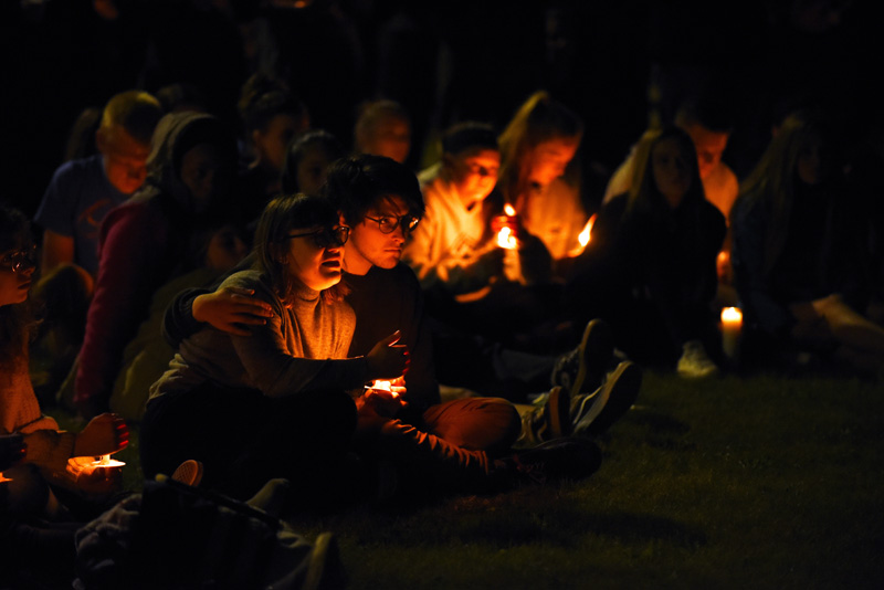 Riley Golding (left) and Noah Jones listen to educators and friends speak about Isabelle Manahan during a vigil at Great Salt Bay Community School in Damariscotta on Monday, June 11. (Jessica Picard photo)