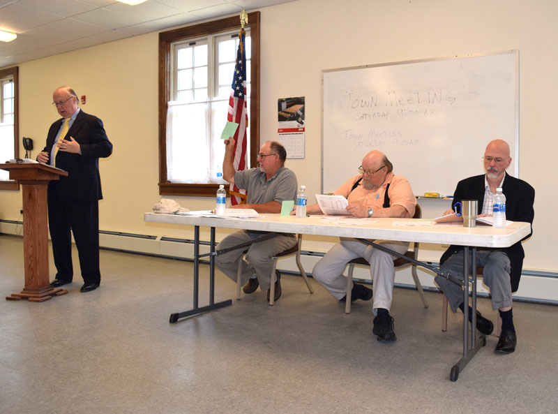 From left: Moderator Robert Lenna, Third Selectman Allan Moeller, Second Selectman Dwight Keene, and First Selectman Dale Hinote discuss warrant article during Dresden's annual town meeting at Pownalborough Hall on Saturday, June 16. (Jessica Clifford photo)