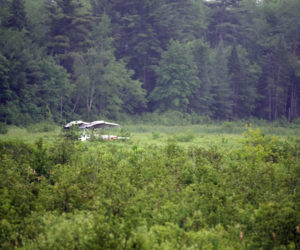 A plane is upside down in a swamp near Woodchuck Way in Jefferson the evening of Saturday, June 23. The two occupants were unhurt, according to Jefferson Fire Chief Walter Morris. (Jessica Picard photo)