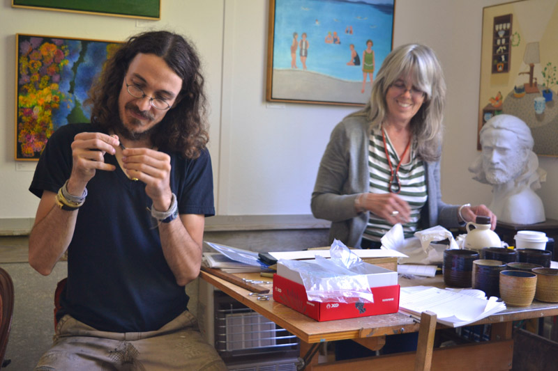 Jewelry-maker Cat Bates and sculptor Daphne Pulsifer gear up for the opening reception at Edison Studio on Friday, June 29. (Christine LaPado-Breglia photo)