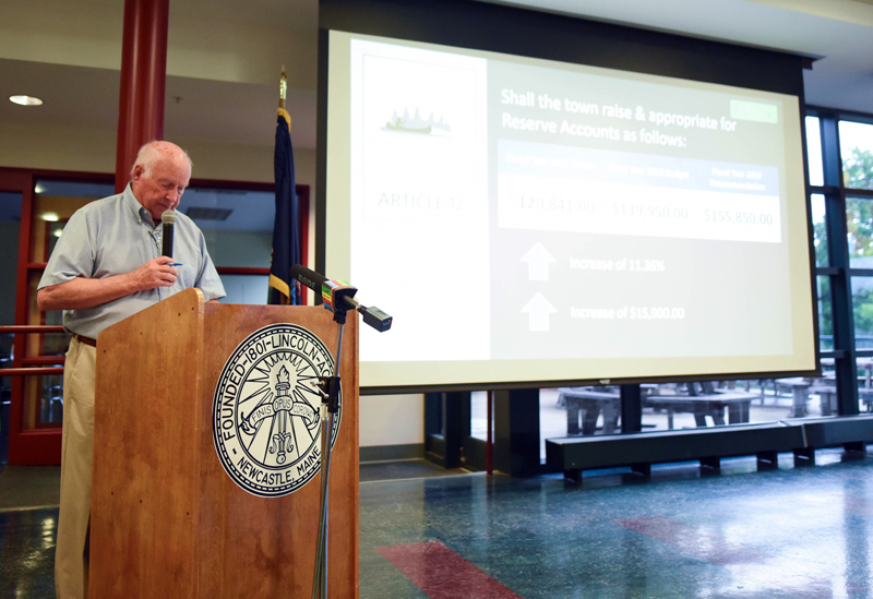 Moderator Don Means reads a question during Newcastle's annual town meeting at Lincoln Academy on Monday, June 18. (Jessica Picard photo)