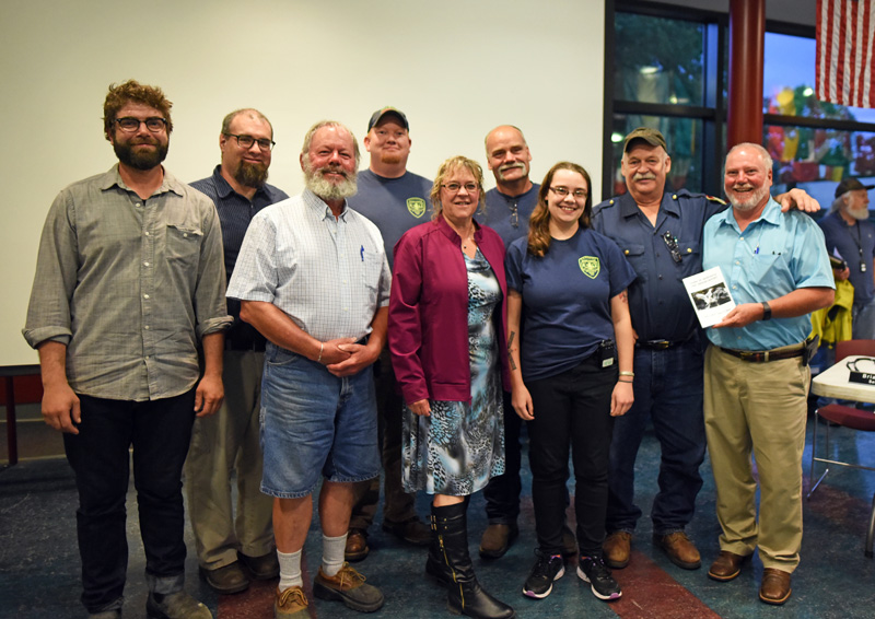 The Newcastle Board of Selectmen presents the Newcastle Fire Department with a copy of the town report, dedicated to the department for its service to the town, Monday, June 18. (Jessica Picard photo)