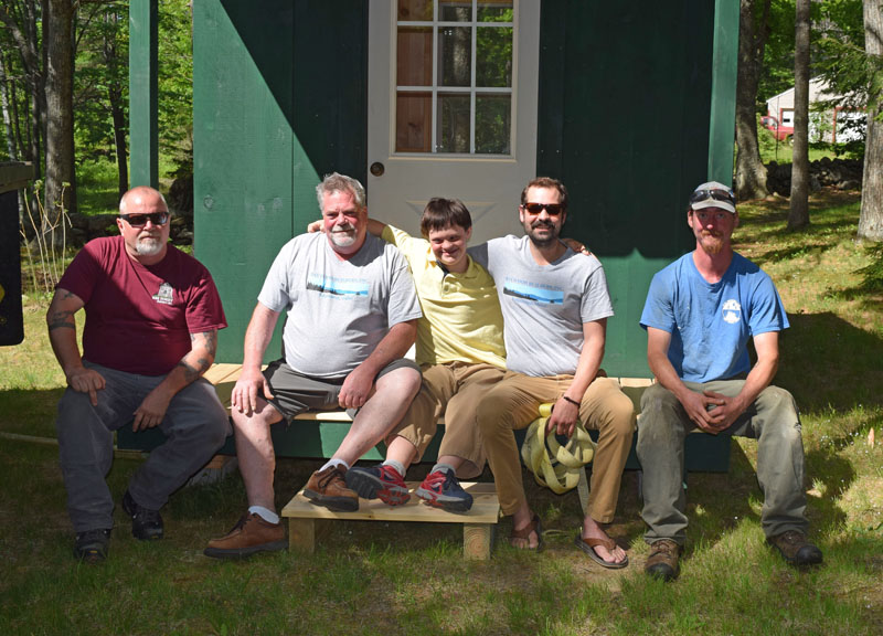 From left: Matt Dorsey, Matthew Jones, John Rankin, Caleb Jones, and Chris Richards sit on the porch of John's new house in Wiscasset. The group delivered the tiny house June 3. (Jessica Clifford photo)