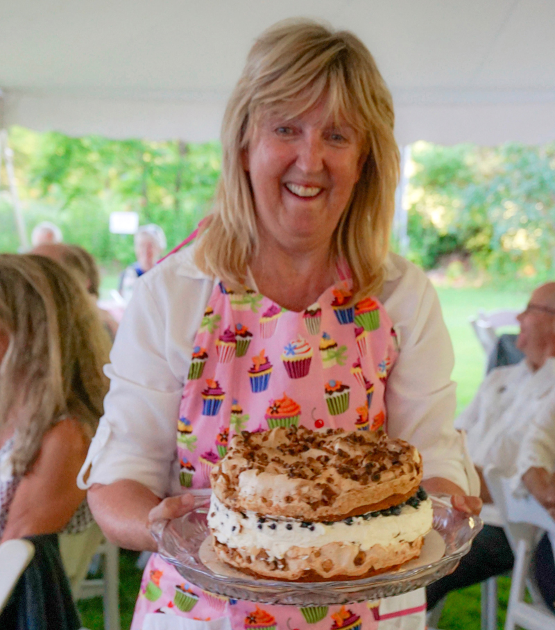 Lincoln County Historical Association volunteer Terri Wells displays a cake during the auction of desserts at last years Kermess. (Photo courtesy Sarah Sutter)