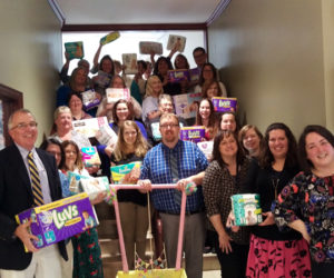 Glenn Hutchinson (left) president of Bath Savings, with Tina Magno (fourth from right), Jenny Little (right), and employees of the Bath Savings Institution's Bath office with diapers donated.