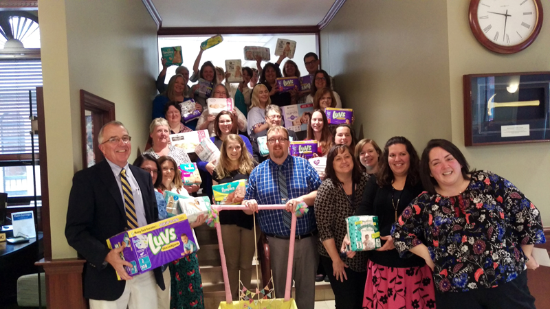 Glenn Hutchinson (left) president of Bath Savings, with Tina Magno (fourth from right), Jenny Little (right), and employees of the Bath Savings Institution's Bath office with diapers donated.