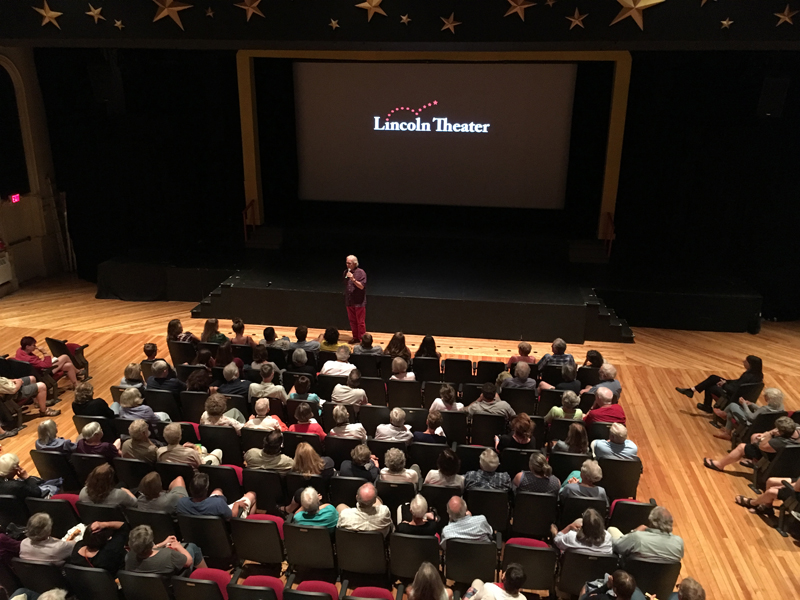 Eliot Daley addresses the audience at Lincoln Theater on the evening of Friday, July 27. (Photo courtesy Andrew Fenniman)