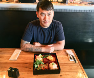 O-Cha Bar & Grill owner Pongsakorn Hanjitsuwan with one of his newest menu items: a bento box. (Suzi Thayer photo)